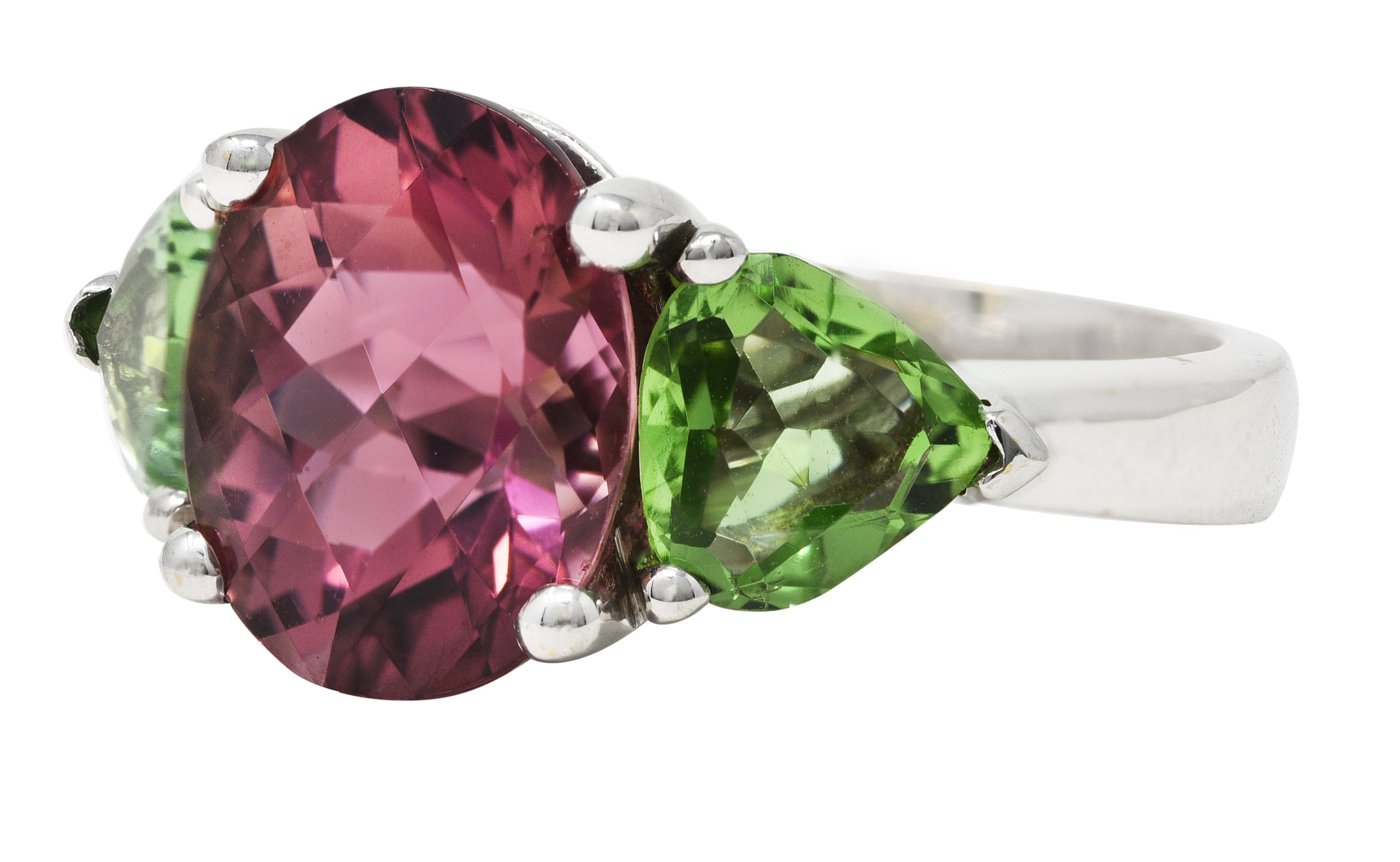 Contemporary 7.23 CTW Oval Cut Pink Tourmaline Peridot 18 Karat White Gold Three Stone Ring Wilson's Estate Jewelry